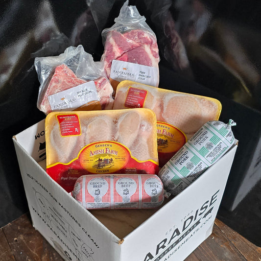 Variety of packaged meats packed a box stacked on cardboard