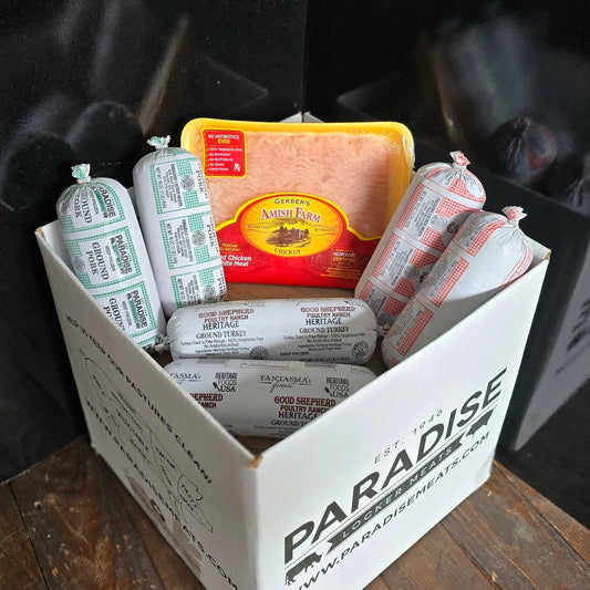 Variety of ground meat options stacked in a box on a wooden cutting board