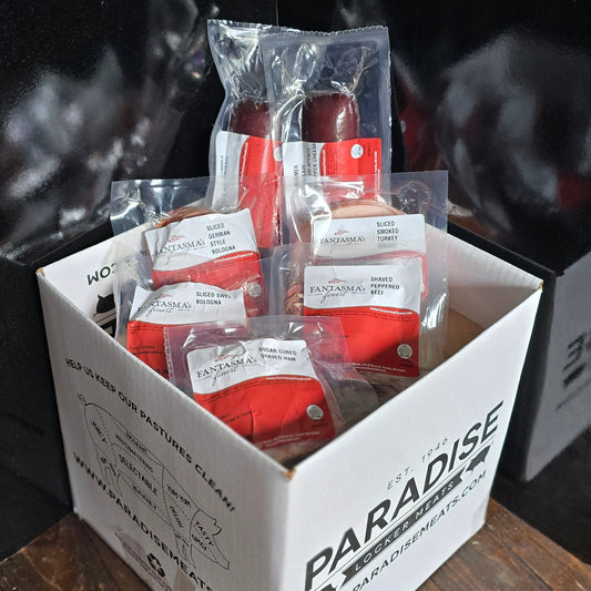 Box of Paradise brand products on a wooden surface with a blurred background