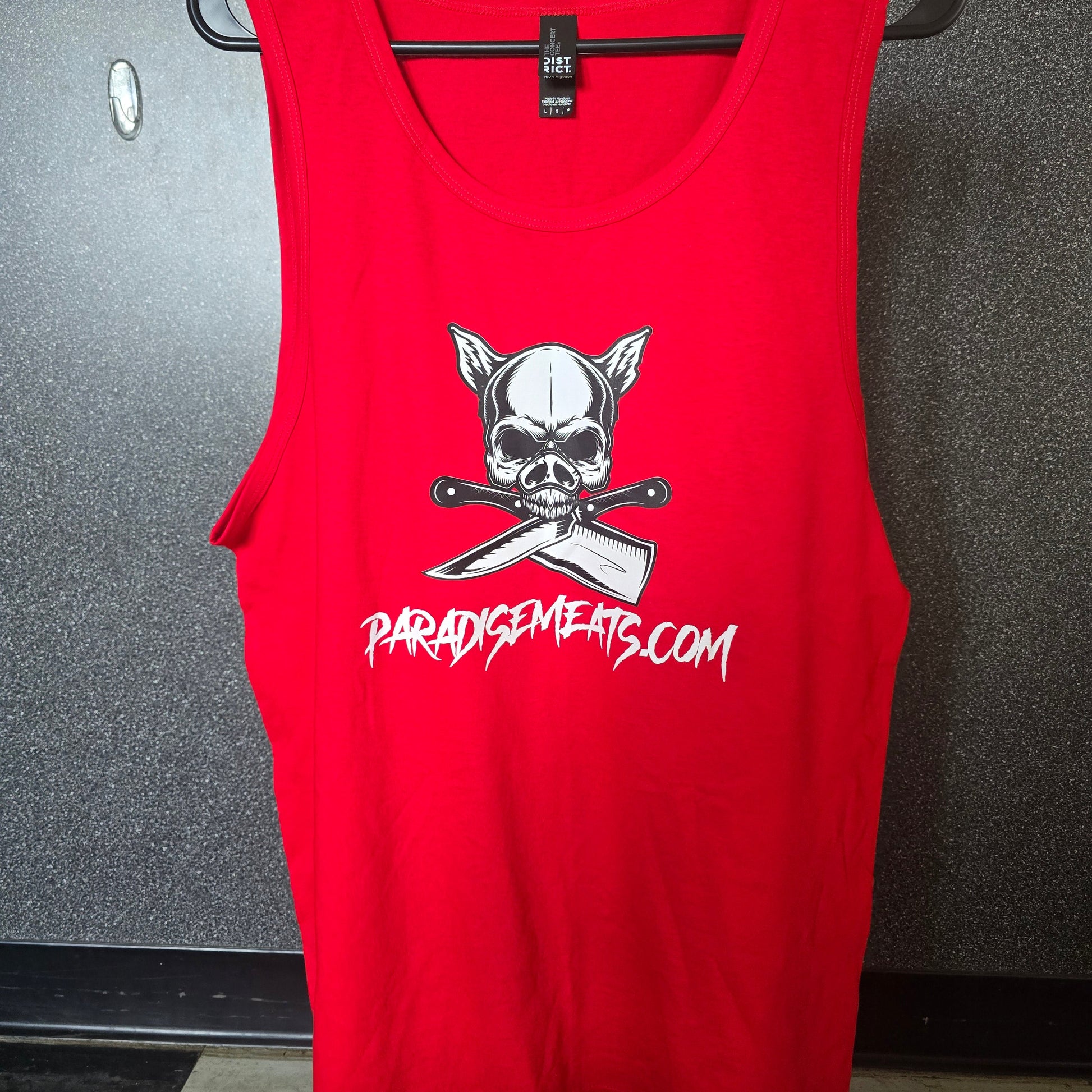 A red sleeveless tank top laid flat on a hanger, featuring a white skull and crossed knives graphic with the text 'PARDYSWAGERS.COM' printed in white on the front.