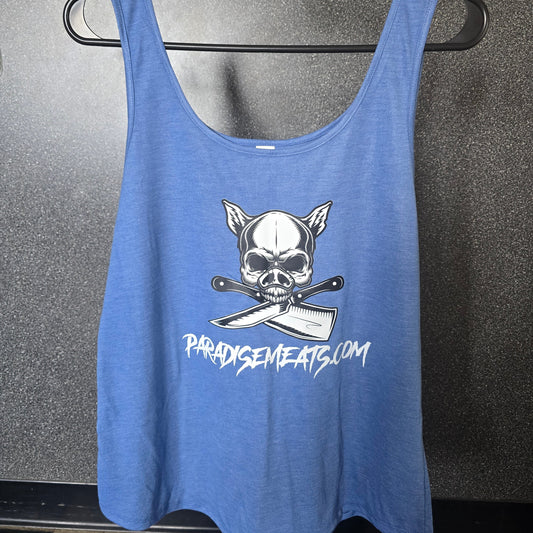 A blue tank top with a white graphic of a skull wearing a chef's hat over crossed knives, with the text 'PARODYCEMENTS.COM' printed below, hanging on a black clothes hanger against a dark gray floor.