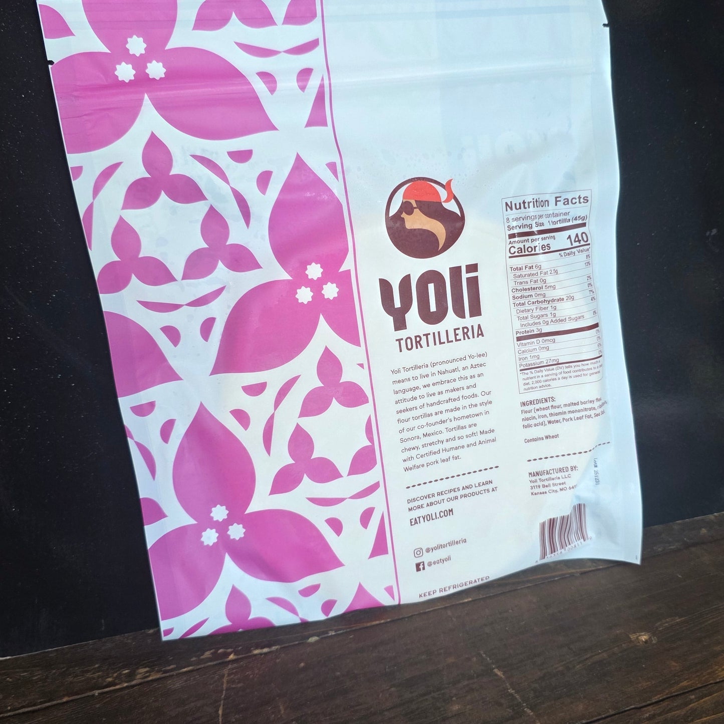 Yoli Tortilleria package with pink and white nutritional information on a wooden surface