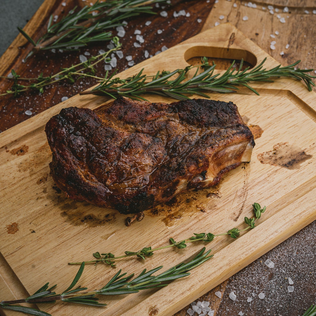 Grilled Pork Ribeye Chop on Cutting Board