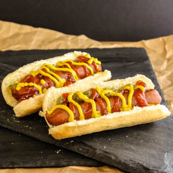 Hot Dogs in Buns with Ketchup, Mustard, and Relish